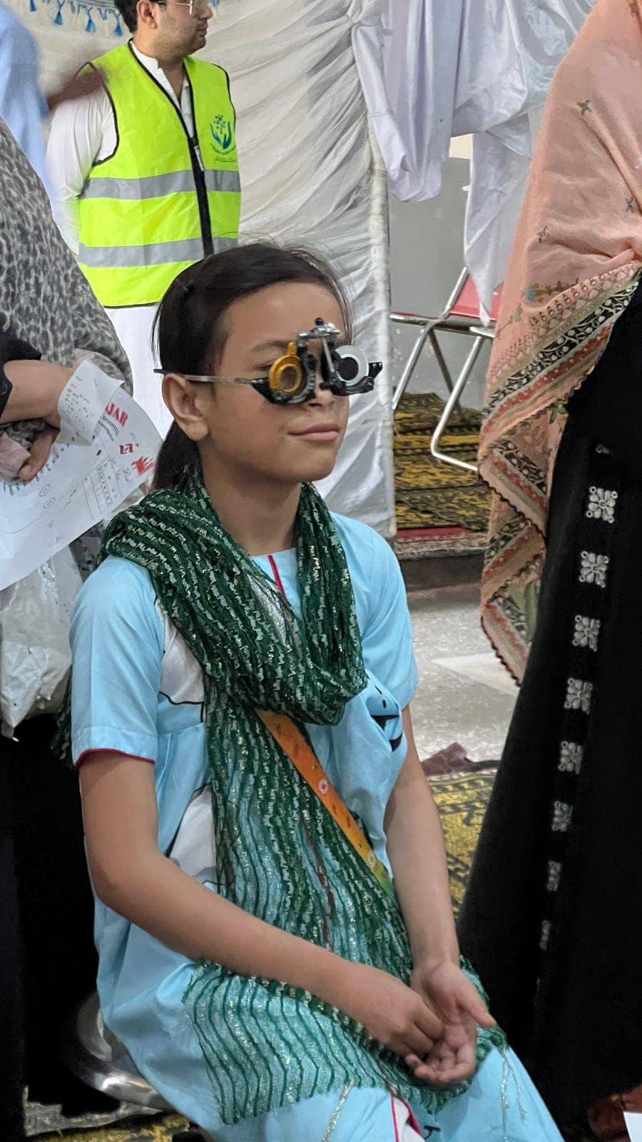 A girl having her eyes tested at the June 2025 free eye camp