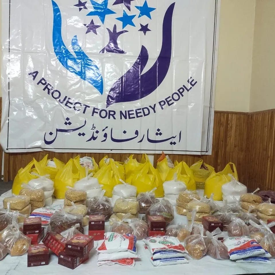 Ration packs lined up under the Karwan-e-Eesaar banner, ready for distribution